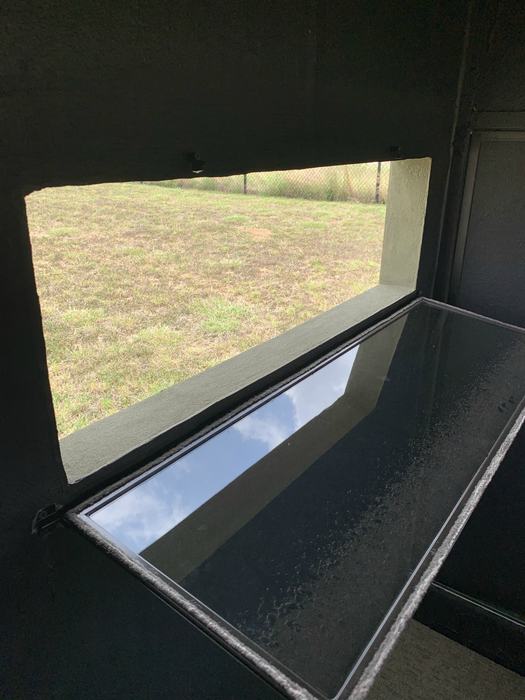Interior view of a DeerView window propped open, showing the double-strength glass pane and clean sill